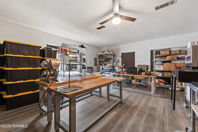 home office with electric panel, ceiling fan, and wood-type flooring