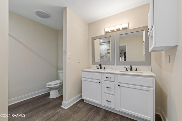 bathroom featuring vanity, wood-type flooring, and toilet