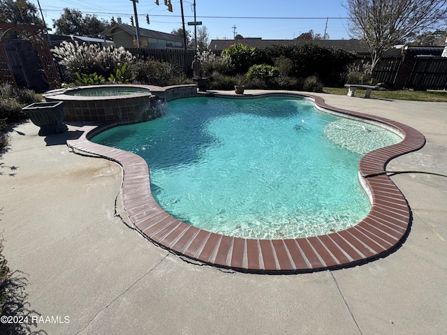 view of pool with a patio area and an in ground hot tub