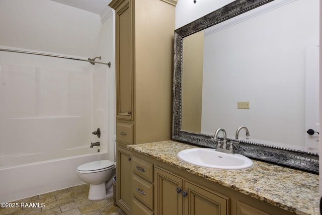 bathroom with stone finish floor, toilet, vanity, and shower / bathing tub combination