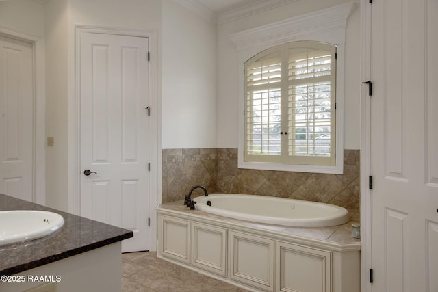 bathroom featuring tile patterned flooring, a bathtub, vanity, and ornamental molding