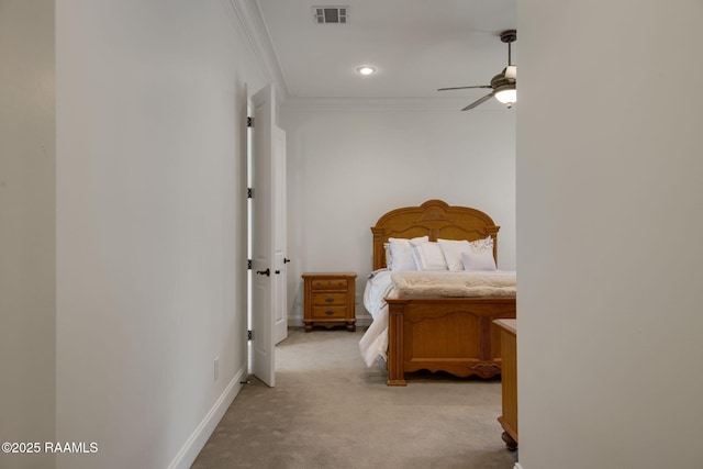 unfurnished bedroom with ceiling fan, light colored carpet, and ornamental molding