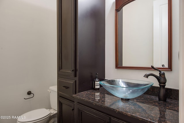 bathroom featuring vanity and toilet