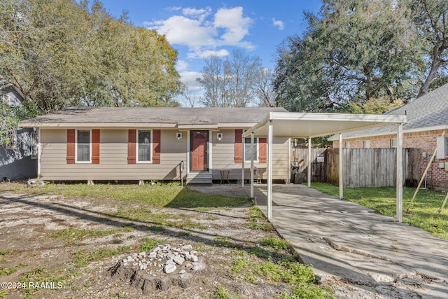 view of front of property with a front lawn and a carport