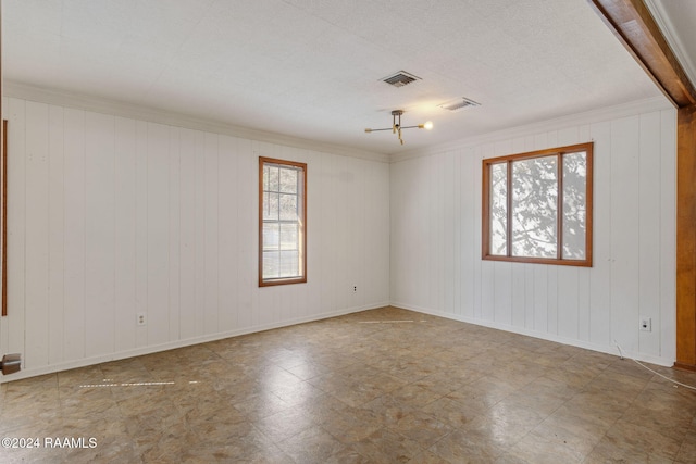 unfurnished room featuring crown molding