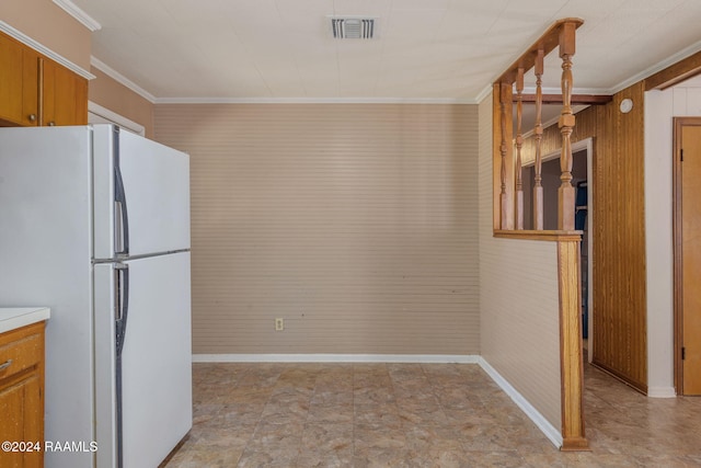 kitchen with white refrigerator and ornamental molding