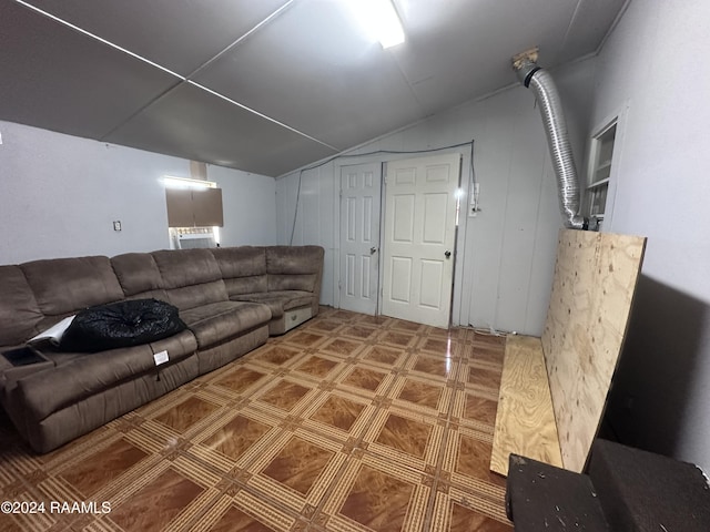 living room featuring cooling unit and lofted ceiling