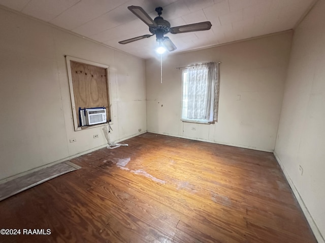 empty room with ceiling fan, hardwood / wood-style floors, and cooling unit