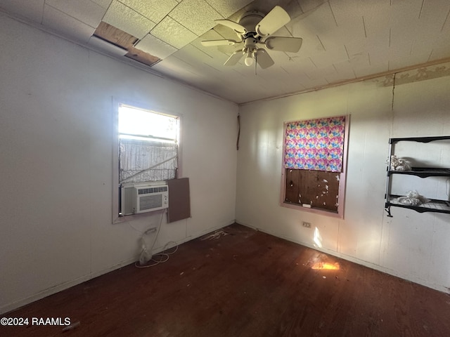 unfurnished room featuring ceiling fan, cooling unit, and dark hardwood / wood-style floors