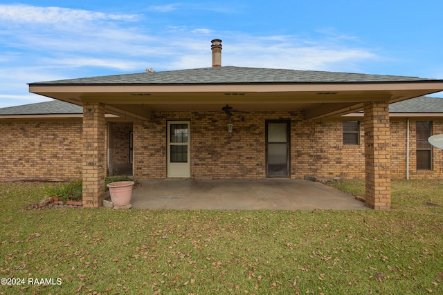 rear view of house with a patio area and a yard