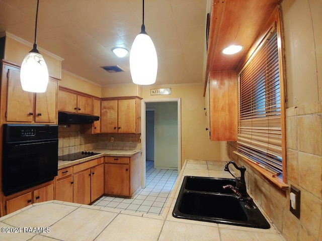 kitchen with sink, tasteful backsplash, decorative light fixtures, black appliances, and ornamental molding