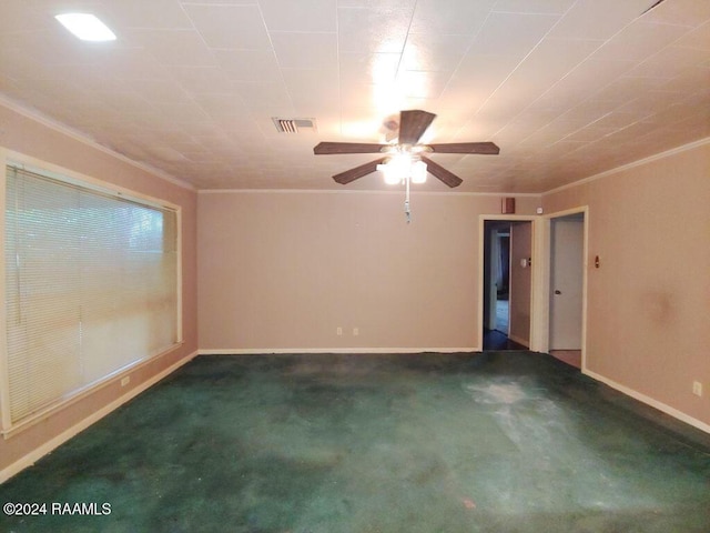 empty room with dark colored carpet and ornamental molding