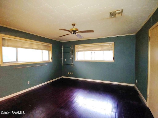 unfurnished room featuring hardwood / wood-style flooring, ceiling fan, a healthy amount of sunlight, and ornamental molding