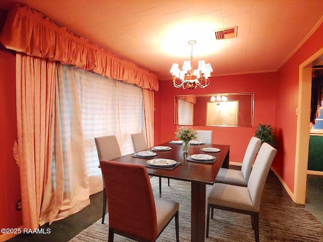 dining space with ornamental molding, visible vents, baseboards, and an inviting chandelier