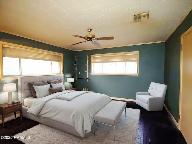 bedroom featuring multiple windows, a ceiling fan, and crown molding