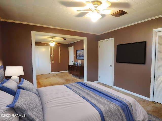 bedroom featuring ornamental molding, a closet, visible vents, and a ceiling fan