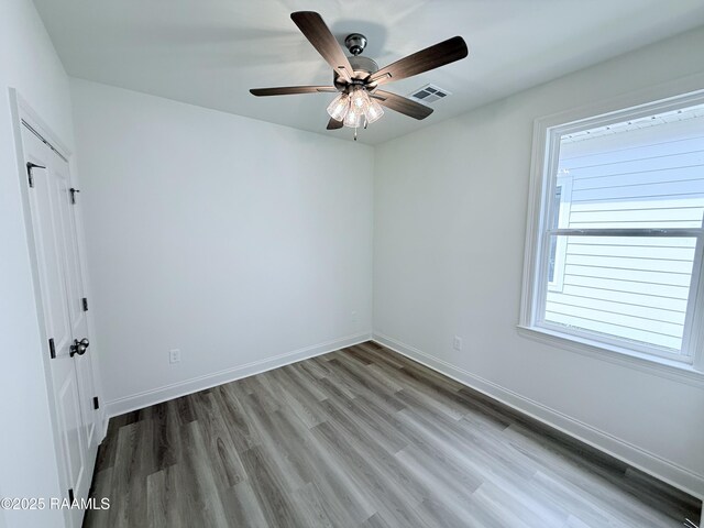 213 Berchman Oaks Dr, Lafayette, LA 70506 - spare room with baseboards, a ceiling fan, wood finished floors, and visible vents
