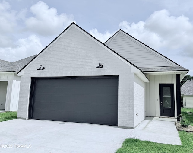 213 Berchman Oaks Dr, Lafayette, LA 70506 - view of front of house with brick siding, a garage, board and batten siding, and driveway