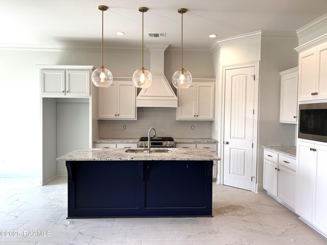 108 Fillmore Way, Lafayette, LA 70506 - kitchen with stainless steel microwave, custom exhaust hood, recessed lighting, a center island with sink, and a sink