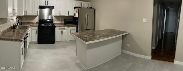 kitchen with white cabinets, appliances with stainless steel finishes, kitchen peninsula, and sink