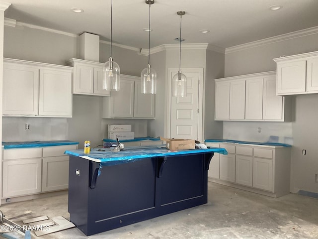 kitchen with white cabinetry, ornamental molding, decorative light fixtures, and a center island