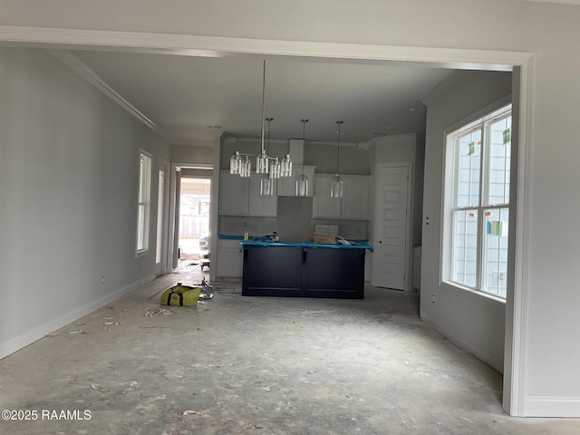 kitchen with ornamental molding, white cabinets, and decorative light fixtures