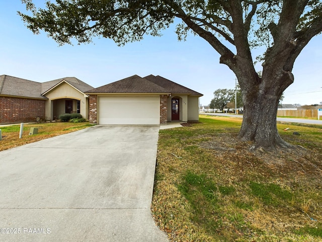 ranch-style home featuring a garage and a front yard