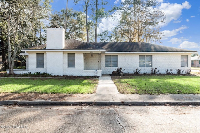 ranch-style house with a front lawn