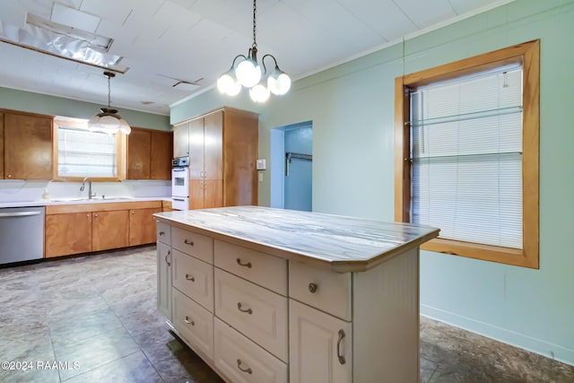 kitchen featuring dishwasher, a center island, hanging light fixtures, oven, and ornamental molding