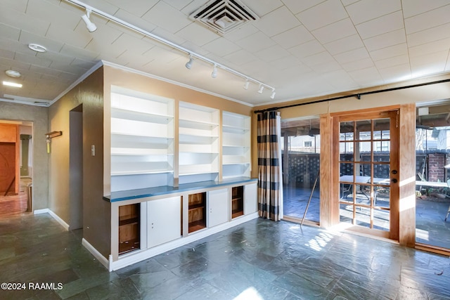 unfurnished living room with crown molding