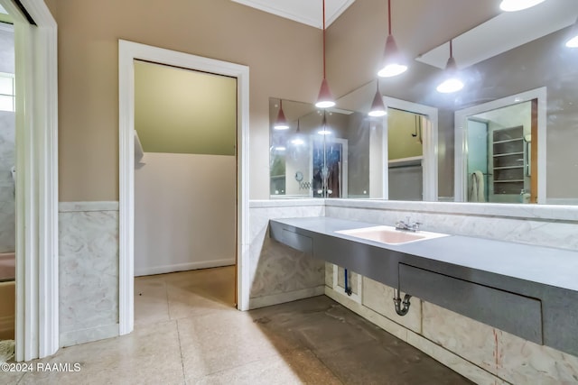 bathroom with ornamental molding and sink