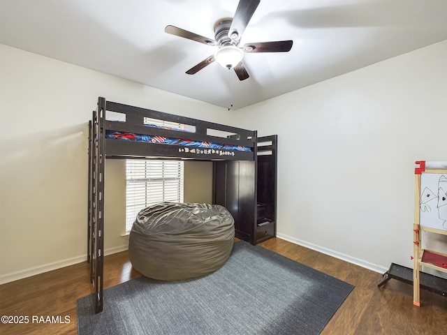 bedroom with ceiling fan and dark wood-type flooring