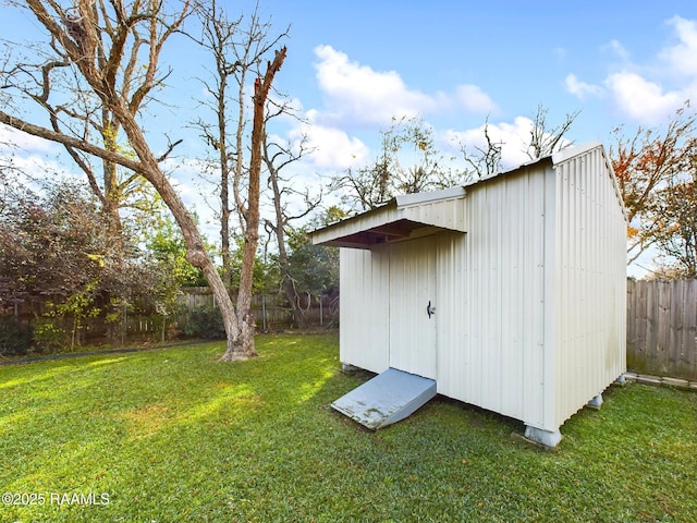 view of outbuilding featuring a yard