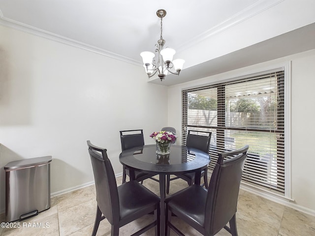 dining room with a notable chandelier and crown molding