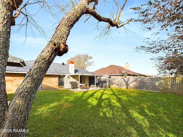 back of property featuring a patio area and a yard