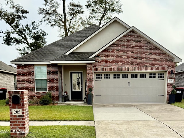 view of front of property with a garage and a front lawn