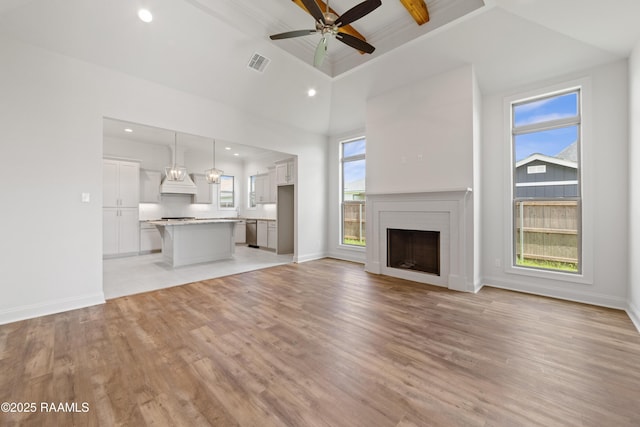 102 Fillmore Way, Lafayette, LA 70506 - unfurnished living room with light wood-style flooring, beam ceiling, high vaulted ceiling, a ceiling fan, and recessed lighting
