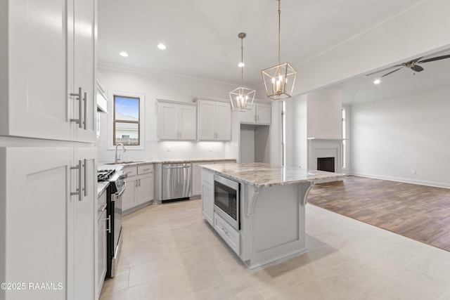 102 Fillmore Way, Lafayette, LA 70506 - kitchen featuring stainless steel appliances, crown molding, a center island, open floor plan, and white cabinetry
