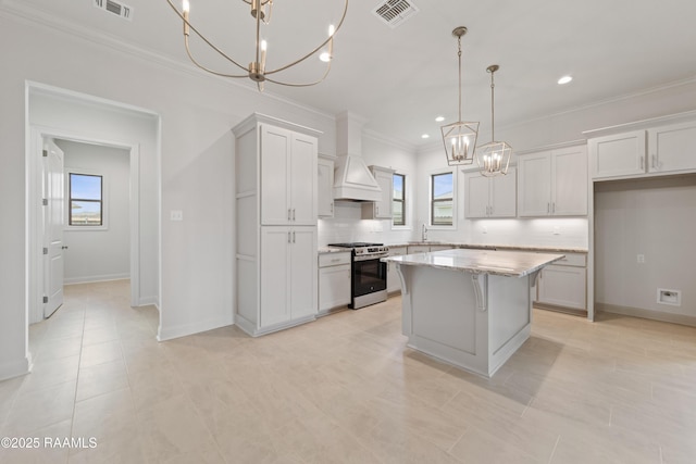 102 Fillmore Way, Lafayette, LA 70506 - kitchen with gas stove, a chandelier, ornamental molding, a kitchen island, and healthy amount of natural light