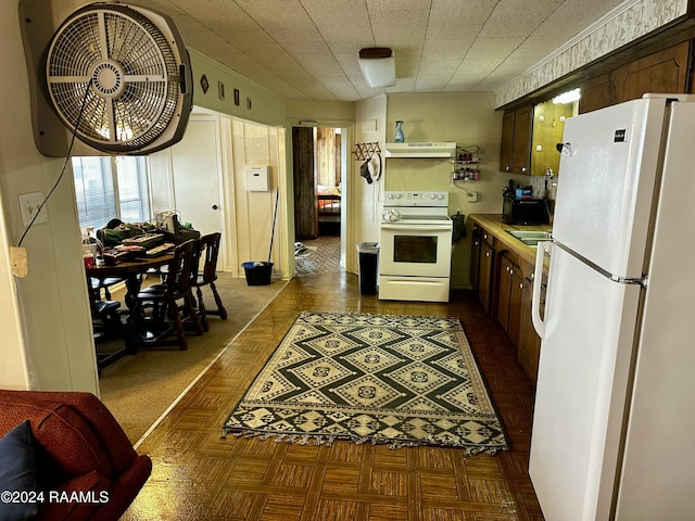 145 Pier 1 Ct, Chauvin, LA 70344 - kitchen with white appliances, ventilation hood, and dark parquet floors