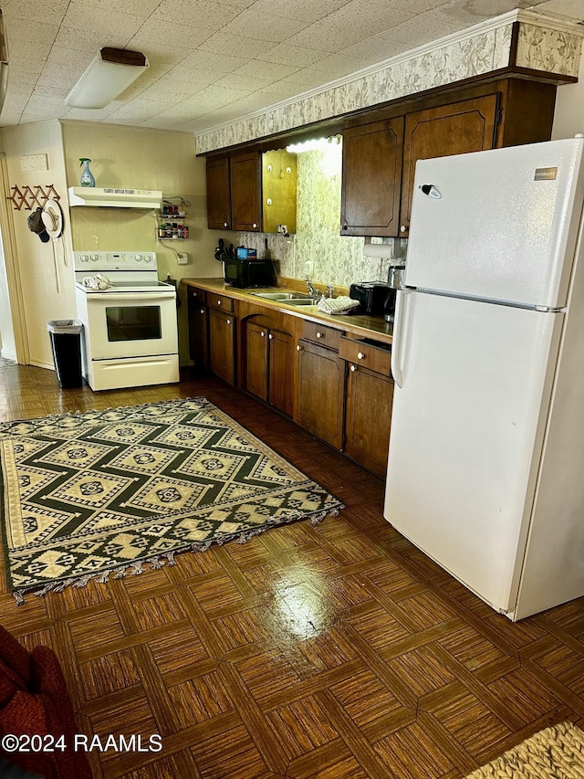 145 Pier 1 Ct, Chauvin, LA 70344 - kitchen with white appliances, dark parquet floors, and sink