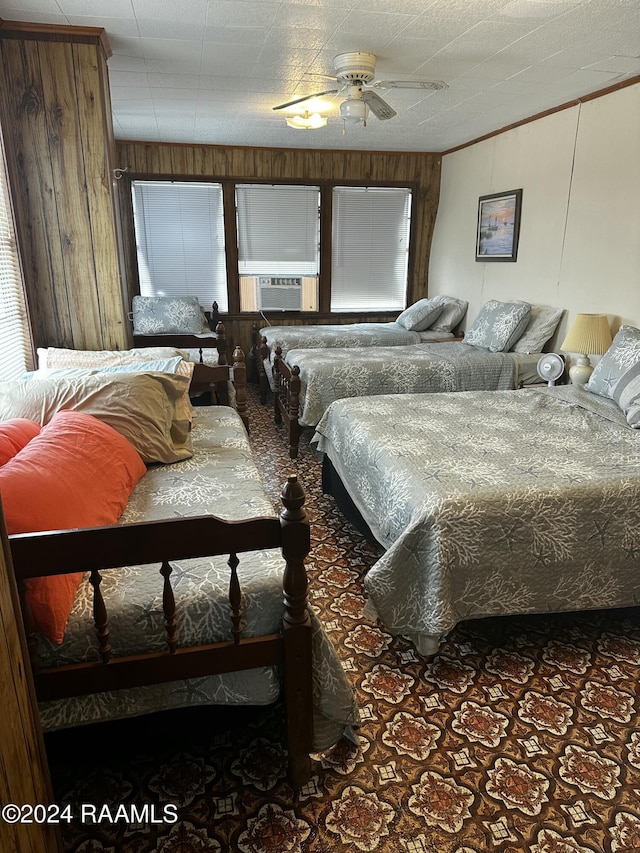 145 Pier 1 Ct, Chauvin, LA 70344 - bedroom with ceiling fan, wooden walls, cooling unit, and dark colored carpet