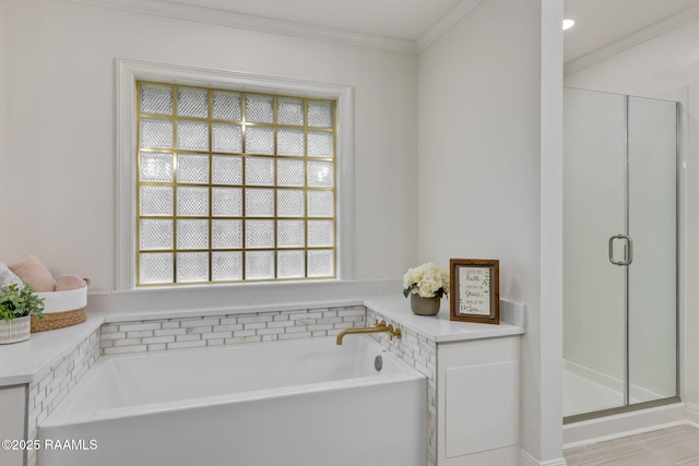 bathroom with separate shower and tub and ornamental molding