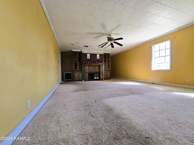 unfurnished living room featuring ceiling fan, a fireplace, and carpet