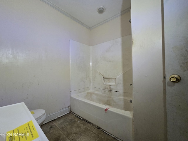 bathroom with tile patterned floors, crown molding, and toilet