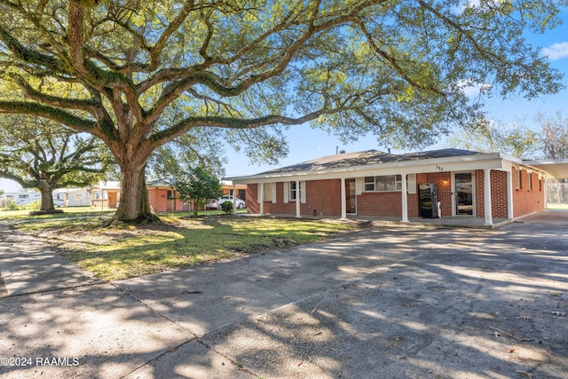 ranch-style house with a front lawn