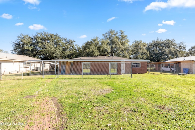 back of property with a lawn