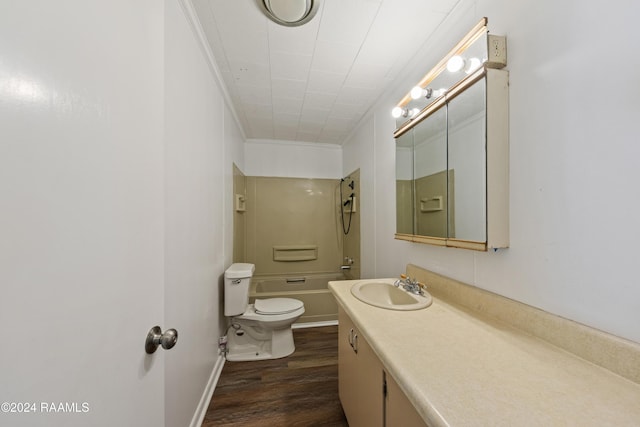 full bathroom with ornamental molding,  shower combination, vanity, hardwood / wood-style flooring, and toilet