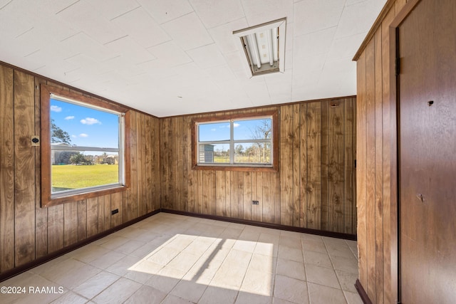 unfurnished room featuring wood walls