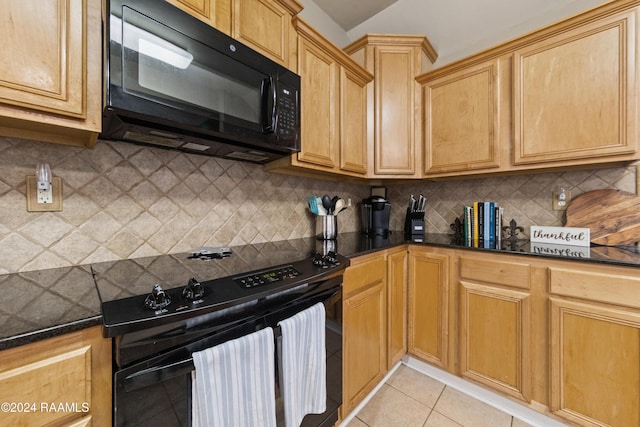 kitchen featuring backsplash, dark stone countertops, light tile patterned flooring, and black appliances